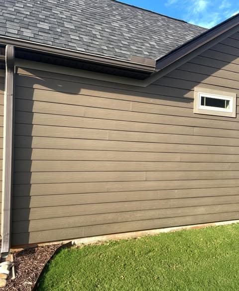 Close-up of freshly painted exterior siding in taupe-brown with dark charcoal trim and fascia, showing clean lines and professional exterior painting finish in Bedminster, New Jersey